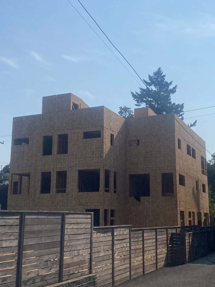 Three-story modern infill building framed with OSB sheathing