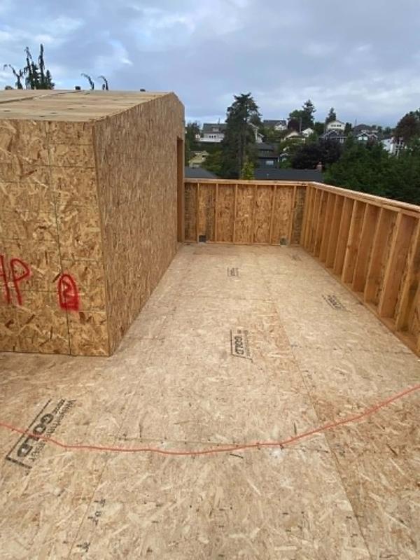Rooftop deck framed with OSB decking overlooking the neighborhood