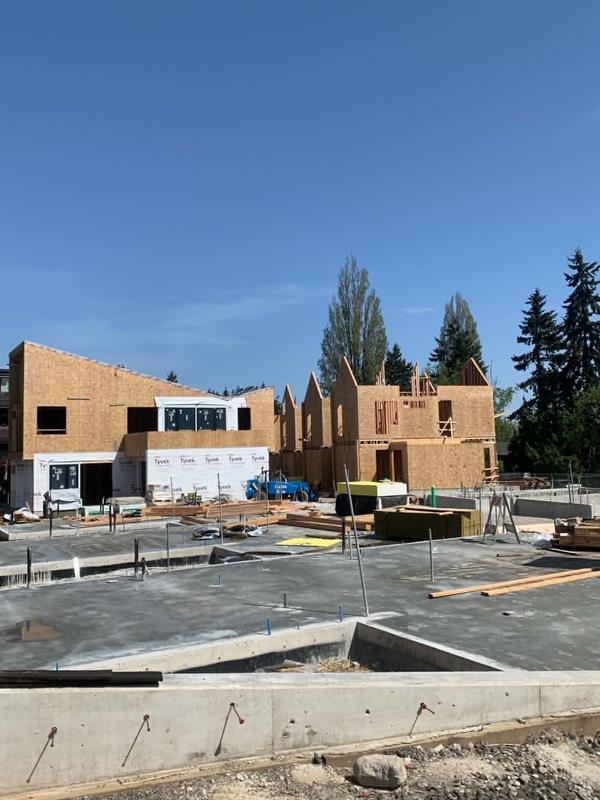 Multi-building townhome development at foundation and early framing stage
