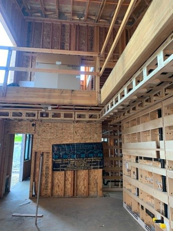 Vaulted great room interior framing with engineered lumber beams