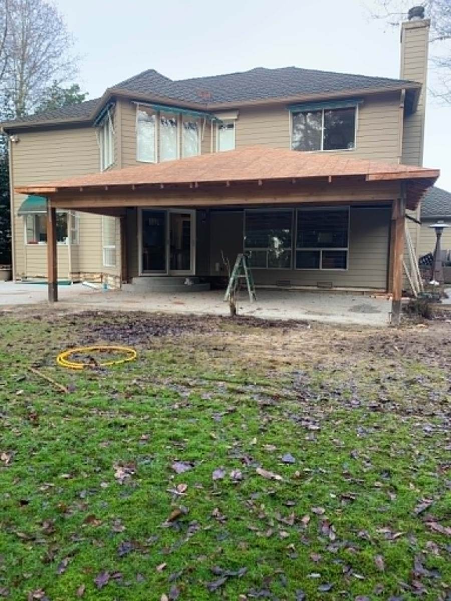 Finished covered deck and patio addition with sliding glass doors