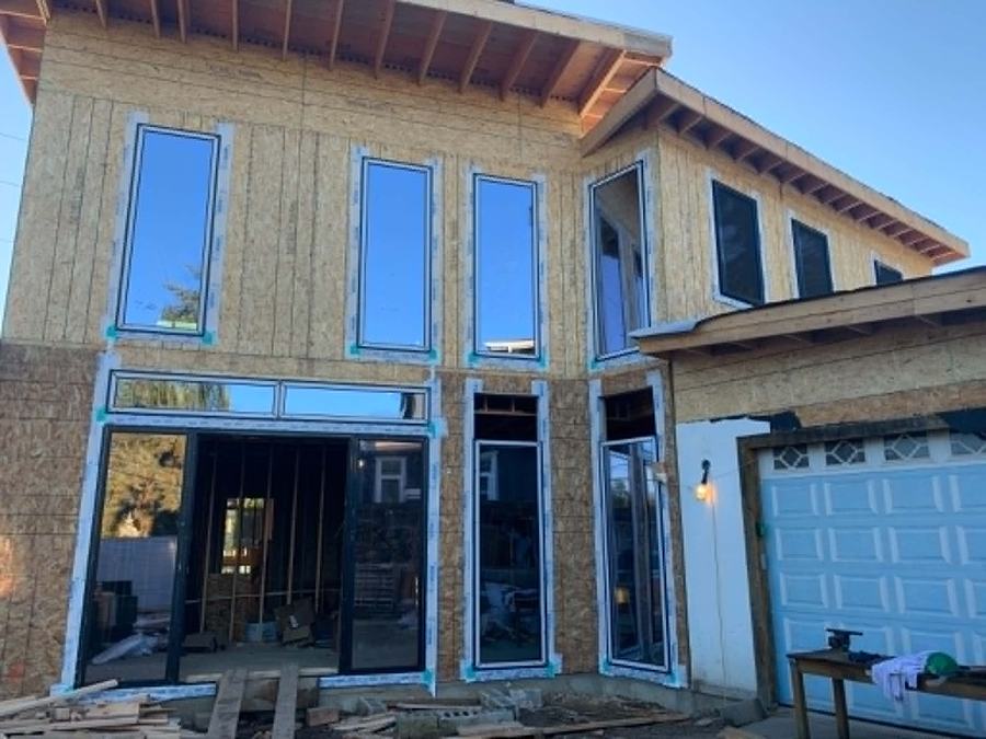 New construction window installation on a two-story home